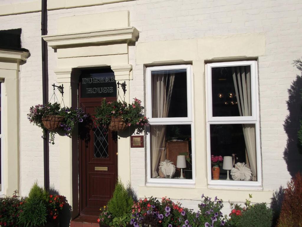 a white house with flowers in a window at Durham house hotel in Gateshead