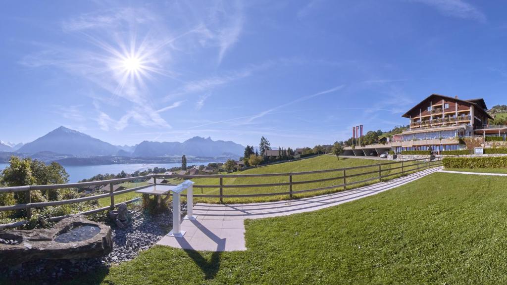 a house on a hill with a view of a lake at Hotel Restaurant Panorama in Aeschlen