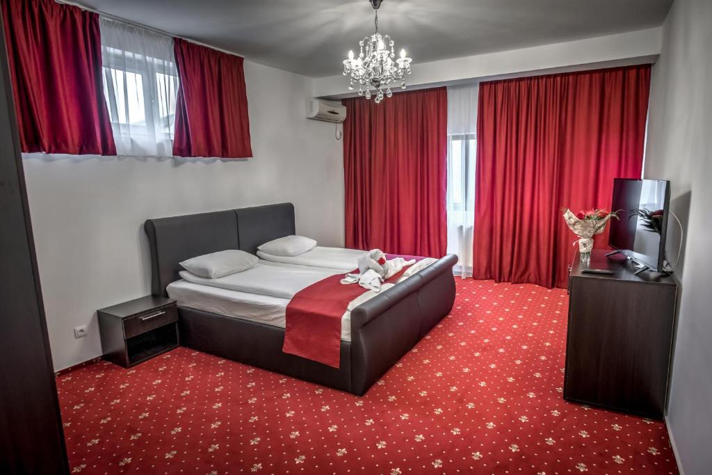 a bedroom with a bed with a red carpet at Hotel Elisabeta in Bucharest