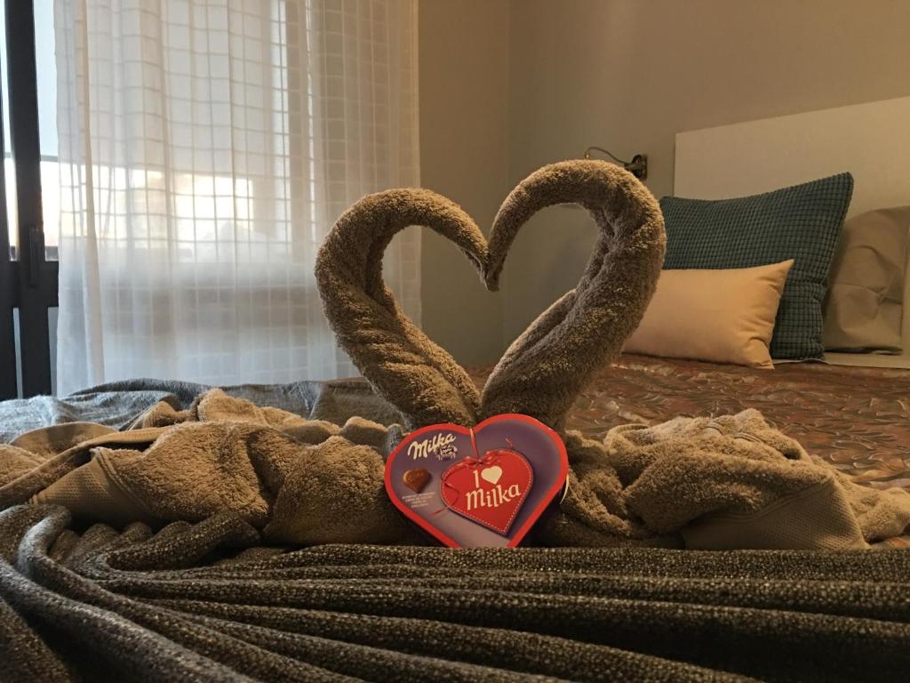 two heart shaped towels on top of a bed at Invicta House Serpa Pinto in Porto