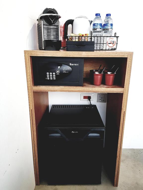 a shelf with a coffee maker and a microwave at Art&#39;otel Ximending Taipei in Taipei