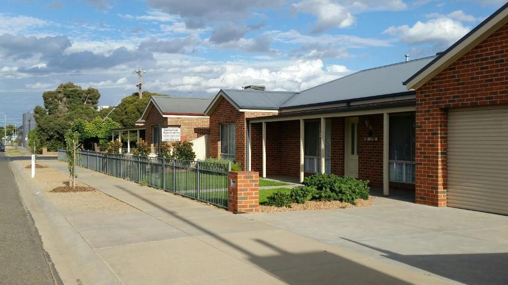 a brick house on the side of a street at Numurkah Self Contained Apartments - The Saxton in Numurkah