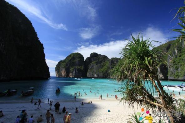 a group of people on a beach in the water at Best Rent a Room in Nai Yang Beach