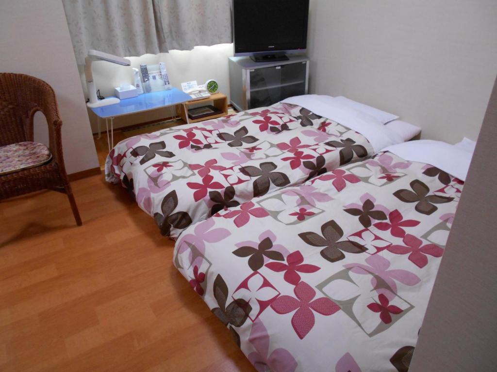 Postel nebo postele na pokoji v ubytování New Central Hotel Katsuta