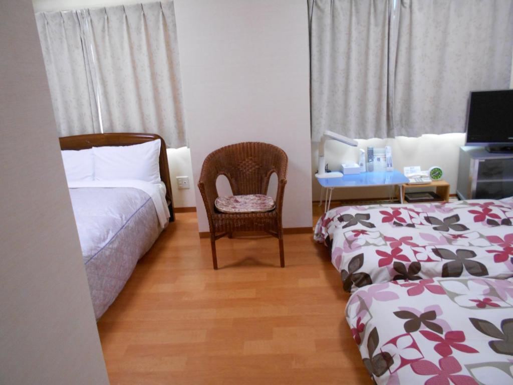 Postel nebo postele na pokoji v ubytování New Central Hotel Katsuta