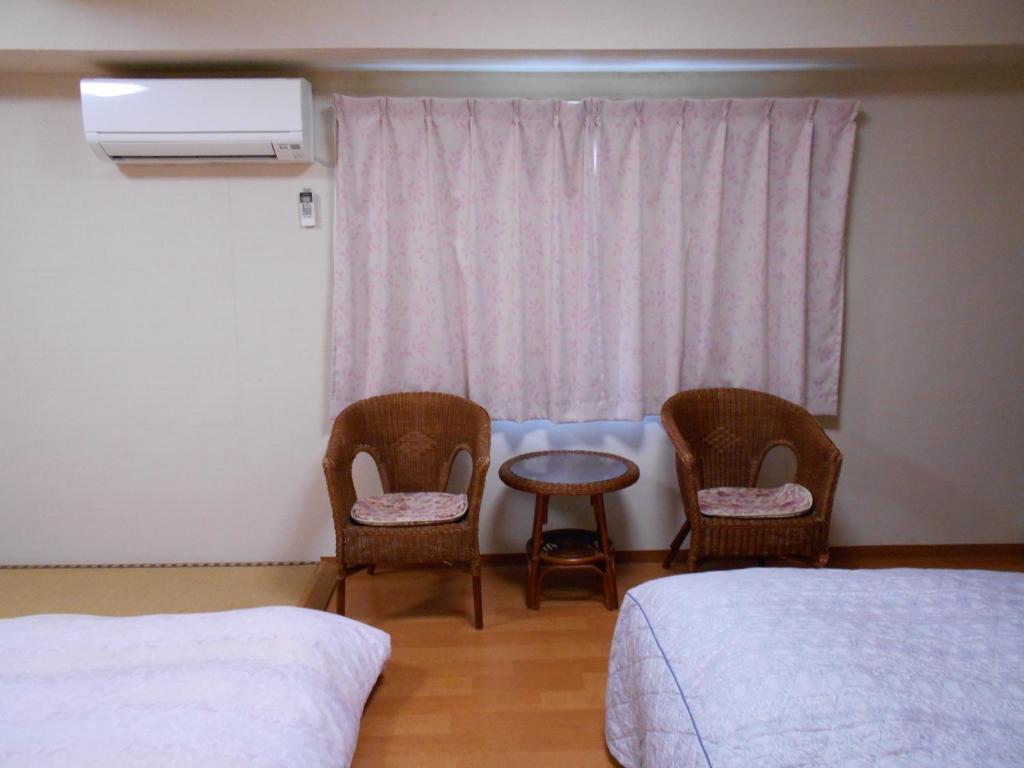Postel nebo postele na pokoji v ubytování New Central Hotel Katsuta