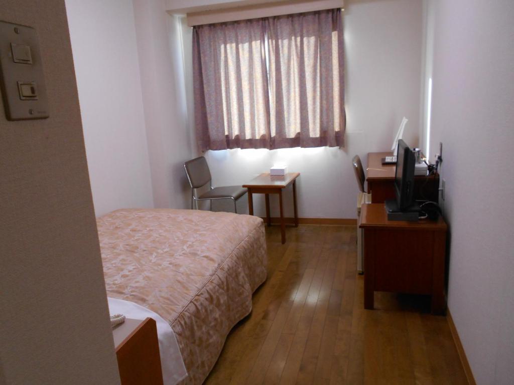 Postel nebo postele na pokoji v ubytování New Central Hotel Katsuta