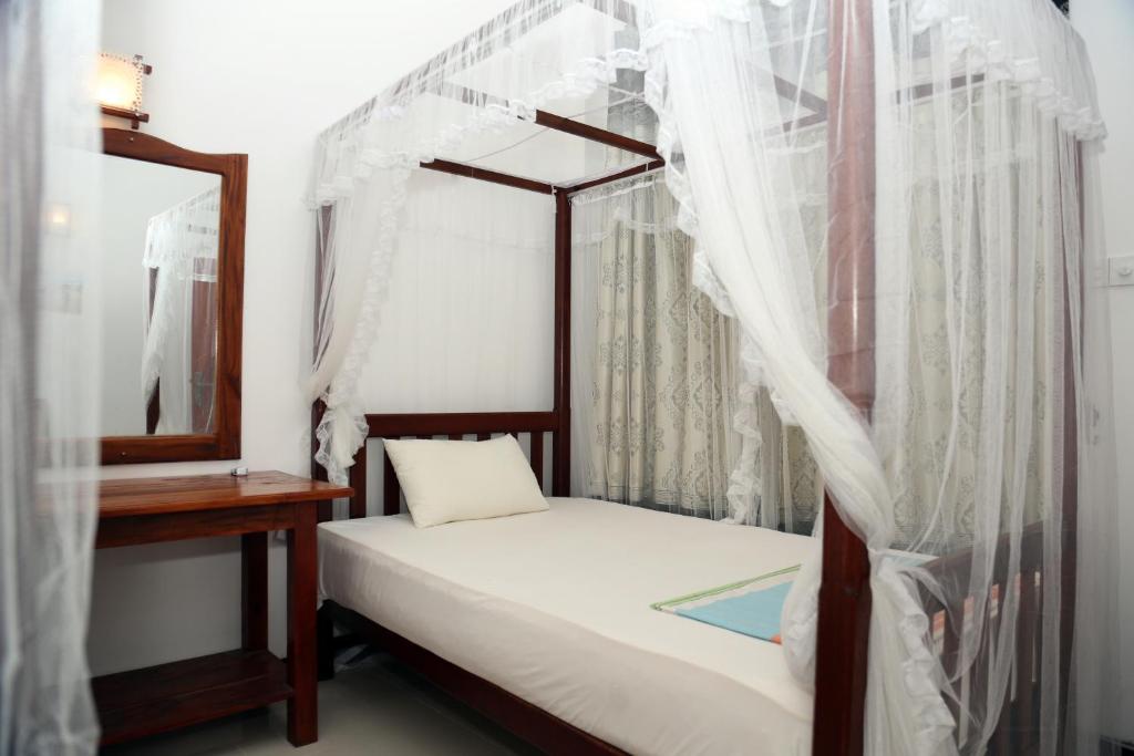 Postel nebo postele na pokoji v ubytování Gihan Guesthouse