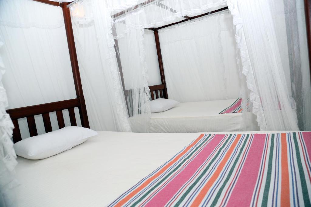 Postel nebo postele na pokoji v ubytování Gihan Guesthouse