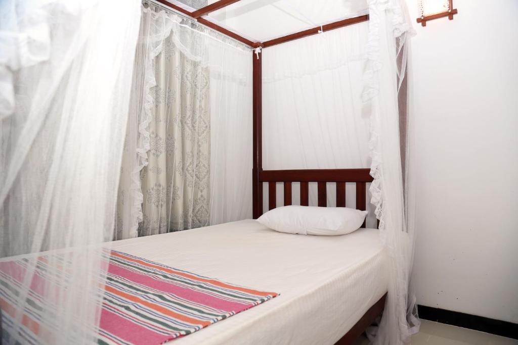 Postel nebo postele na pokoji v ubytování Gihan Guesthouse