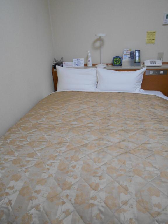 Postel nebo postele na pokoji v ubytování New Central Hotel Katsuta