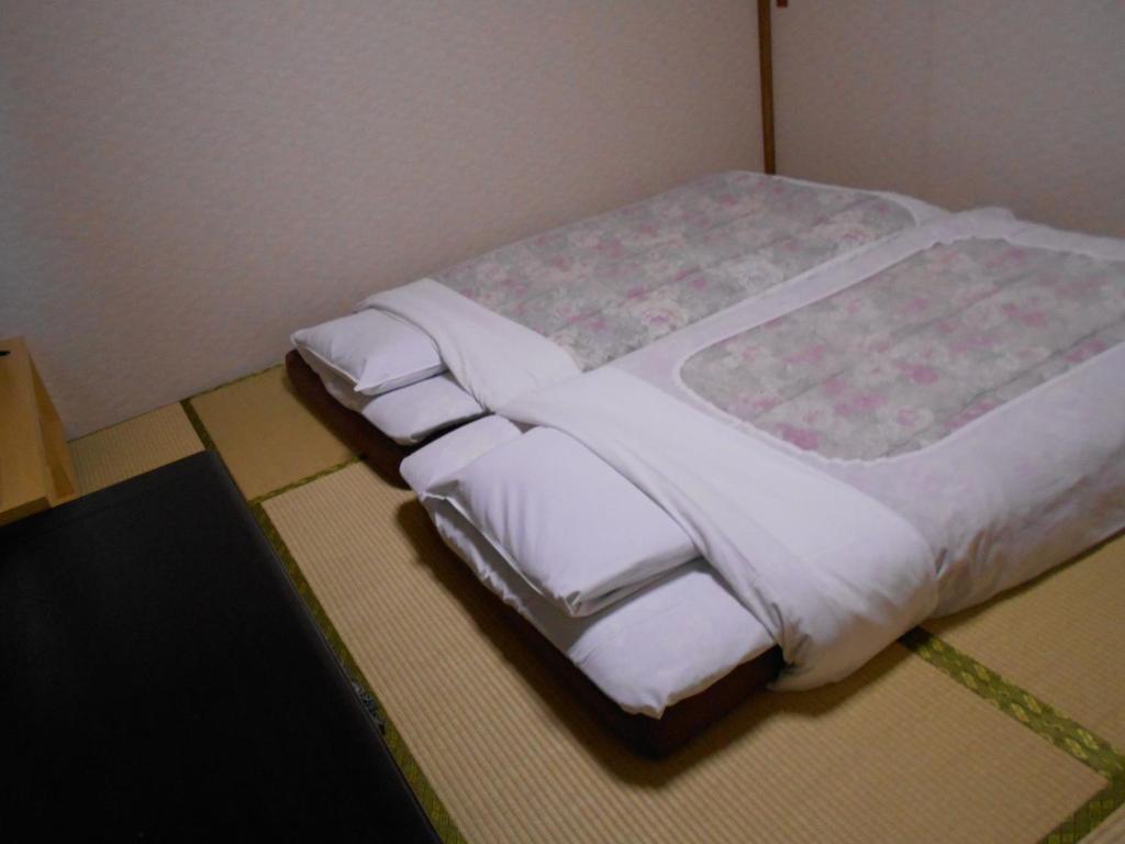 Postel nebo postele na pokoji v ubytování New Central Hotel Katsuta
