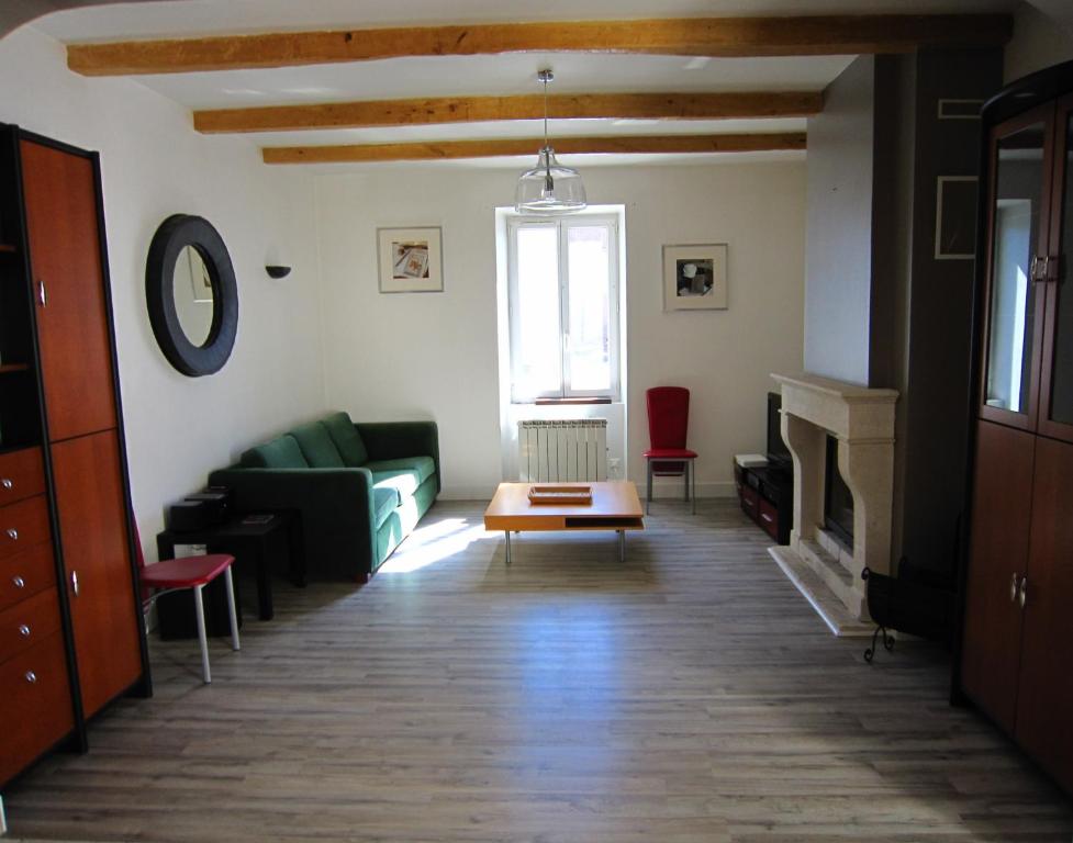 a living room with a couch and a table at Maison de charme à La Rochelle in Croix-Chapeau