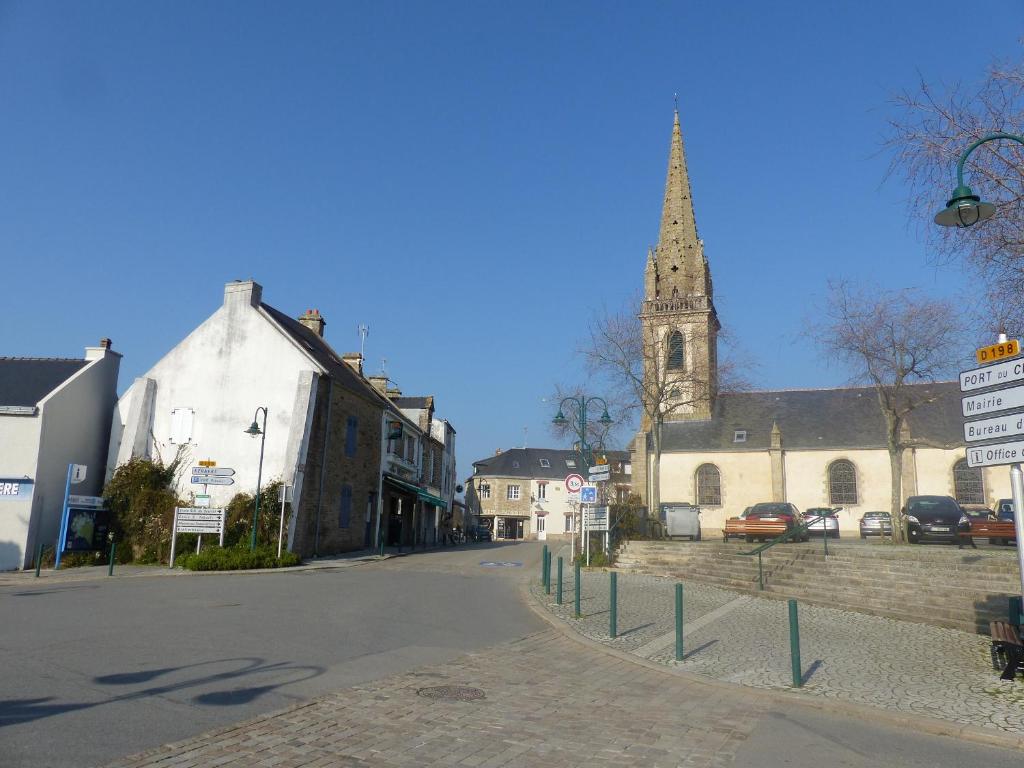 an empty street in a small town with a church at la maison de vincente in Arzon