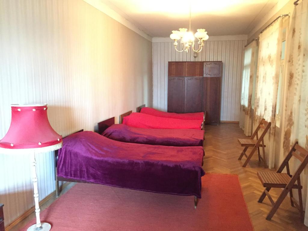 A bed or beds in a room at Guest House Gzirishvili