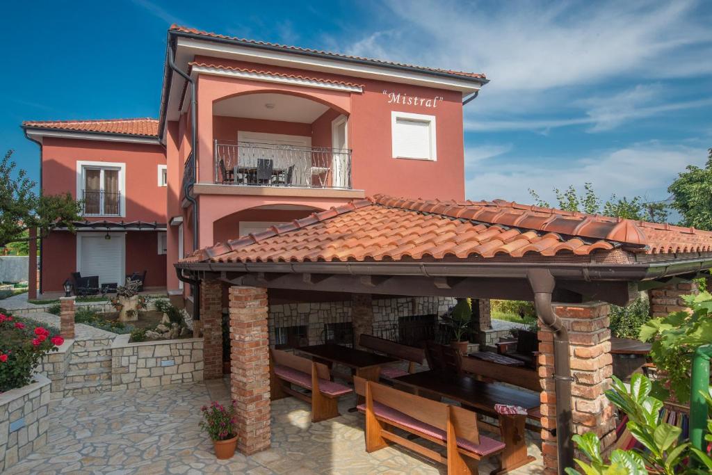 a house with a gazebo in front of it at Mistral Apartments in Lopar