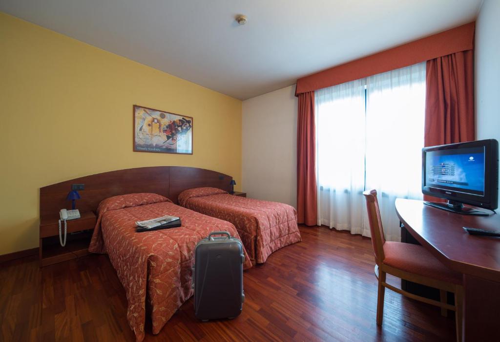 Postel nebo postele na pokoji v ubytování Hotel La Cascata