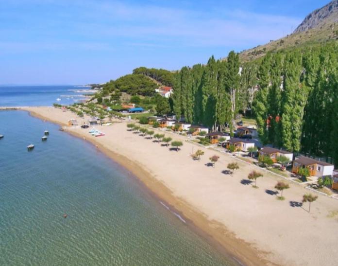 an aerial view of a beach with boats in the water at Apartments Vulić in Omiš