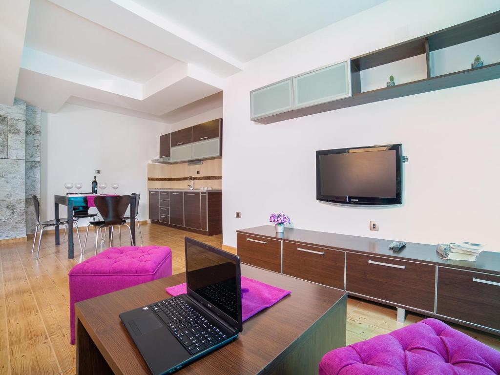 a living room with a laptop on a table at Apartments Raymond in Sveti Stefan