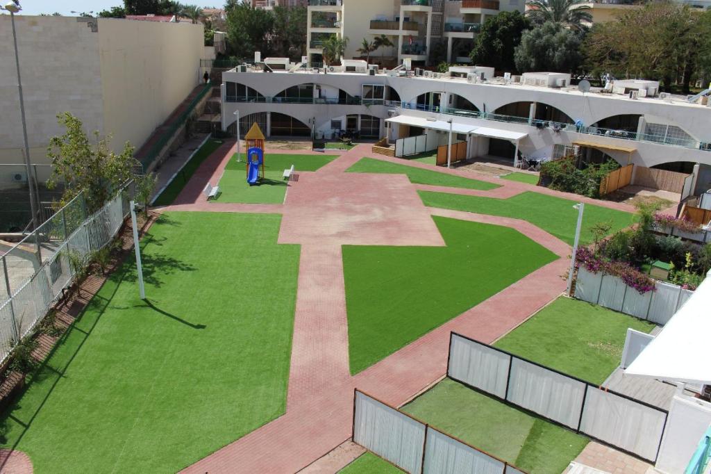 an aerial view of a courtyard with a cross on the grass at Vacation Apartment Eilat in Eilat