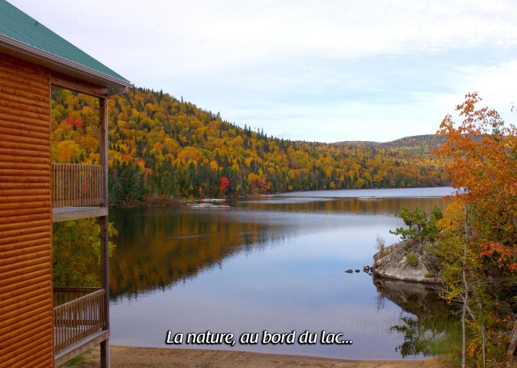 a view of a lake with a house at Auberge La Tanière in Tadoussac