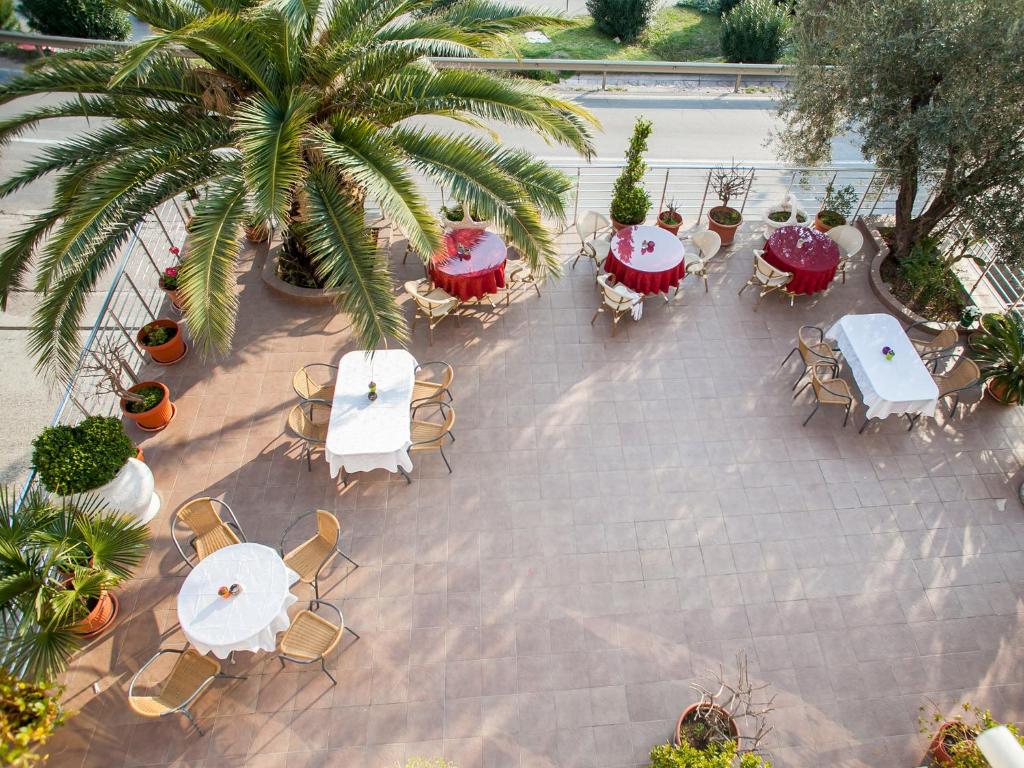 an overhead view of a patio with tables and chairs at Apartments Raymond in Sveti Stefan