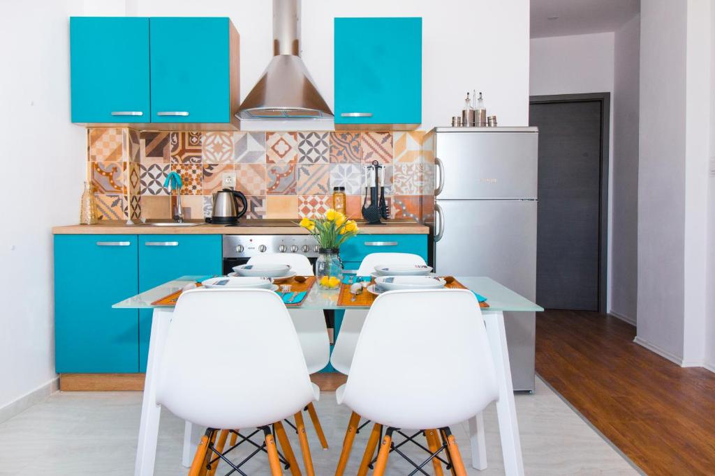 a kitchen with blue cabinets and white appliances at Blue Sun Apartments in Kaštela