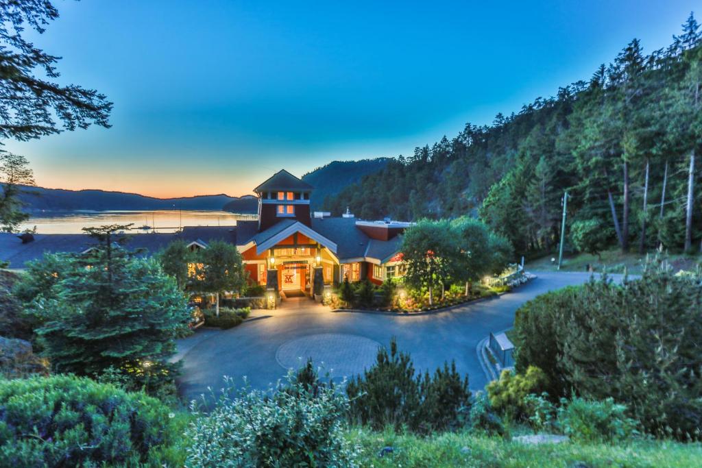 an estate with a church on a lake at night at Poets Cove Resort & Spa in Bedwell Harbour