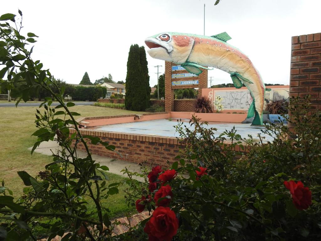 a statue of a fish with its mouth open at Big Trout Motel in Oberon