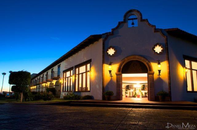 a large white building with an open doorway at night at Hacienda Bajamar in Sonorabampo