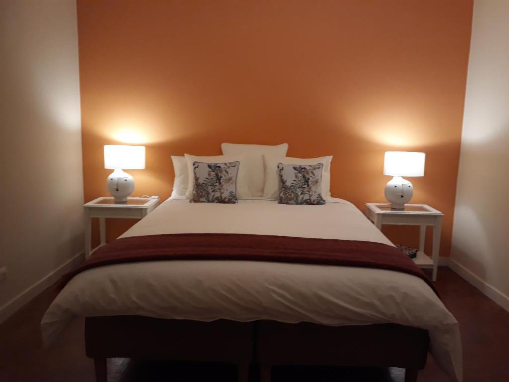 a bedroom with a large bed with two lamps at Stay @Airport in Lisbon