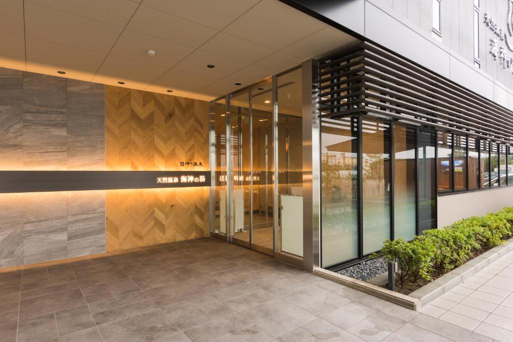 a lobby of a building with glass doors at Dormy Inn EXPRESS Sendai Seaside in Sendai