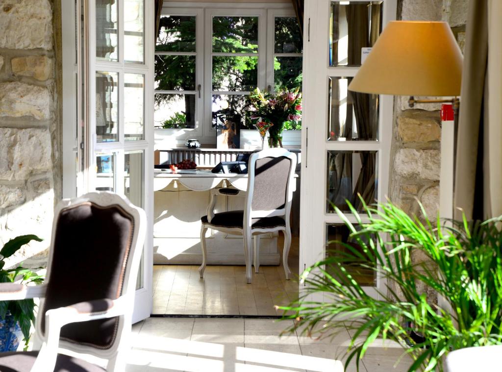 a room with a table and chairs on a patio at Hôtel Eze Hermitage entre Nice et Monaco in Éze