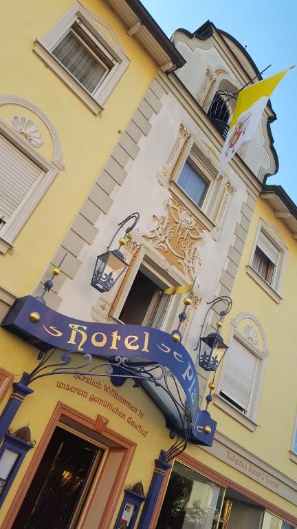 a hotel sign on the side of a building at Hotel Plankl in Altötting