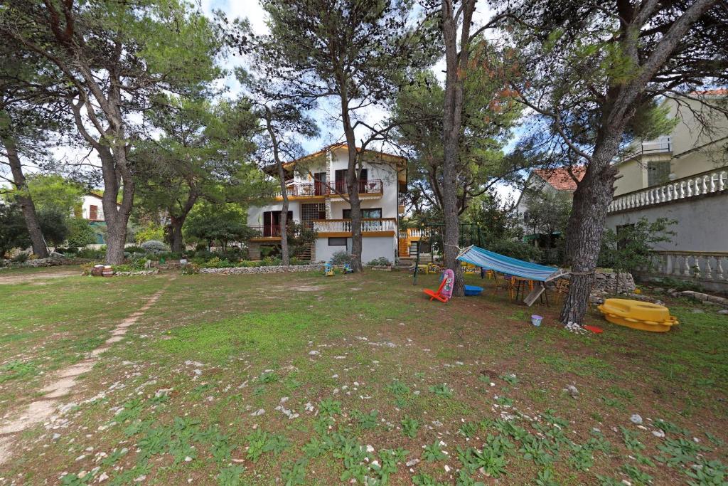 a house with a yard with a tent in front of it at Rooms Jeriko in Vodice