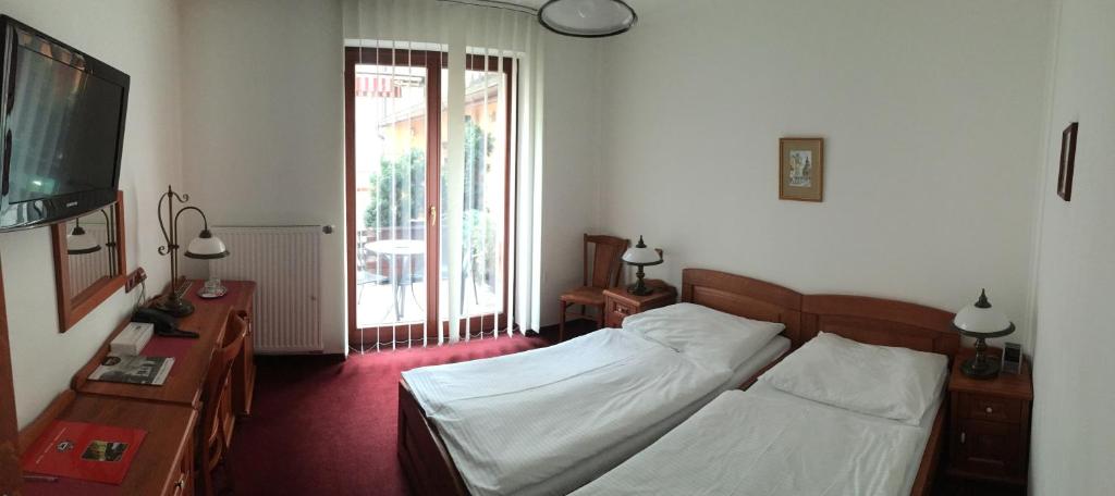 Postel nebo postele na pokoji v ubytování Hotel Pegas Brno
