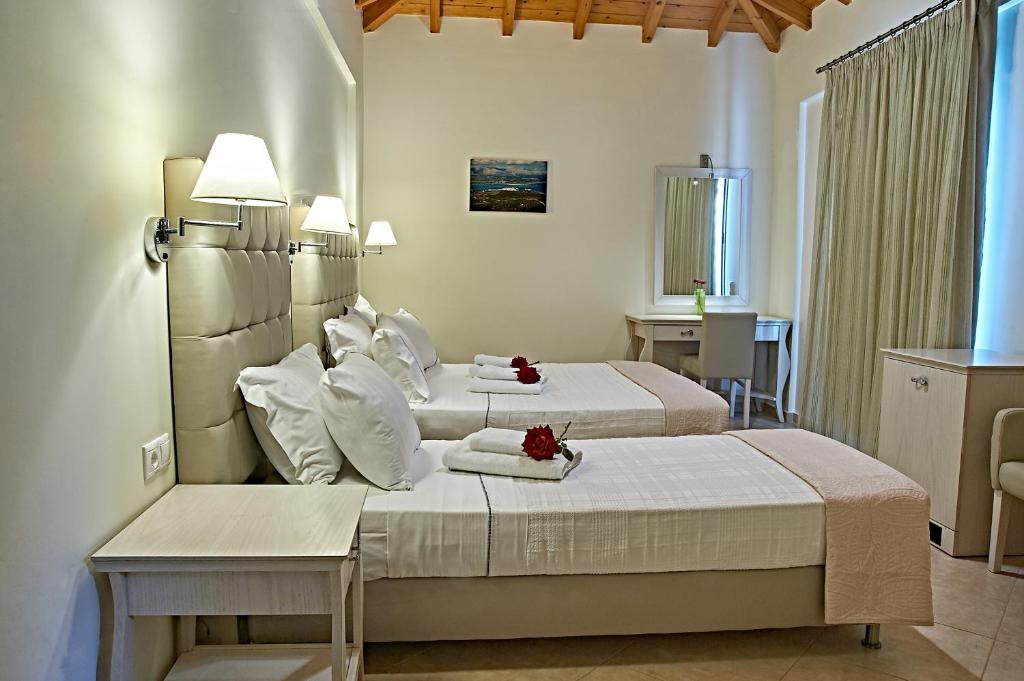 a hotel room with two beds and a table at Element Hotel in Elafonisos
