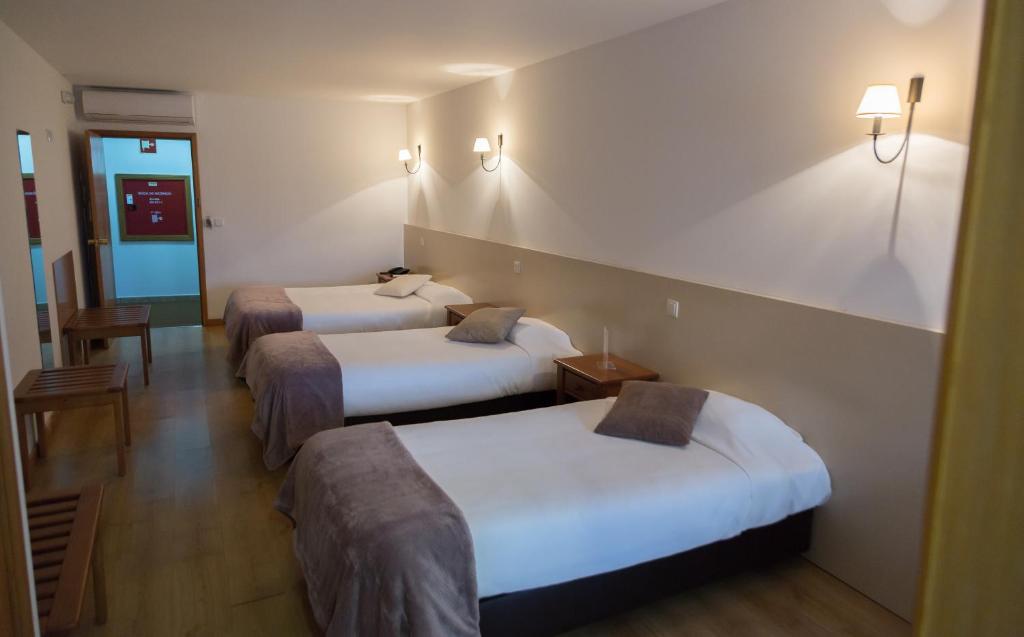 Postel nebo postele na pokoji v ubytování Troia Hotel