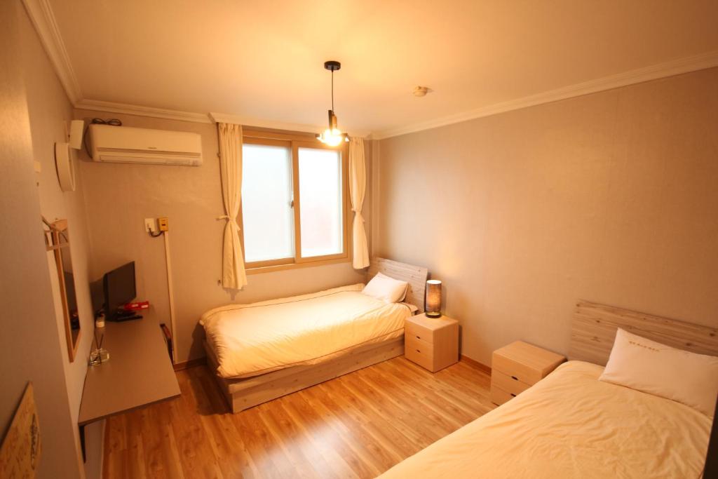 Postel nebo postele na pokoji v ubytování Yeha Guesthouse