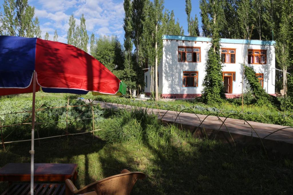 a house and a flag in front of a house at amir homestay in Leh