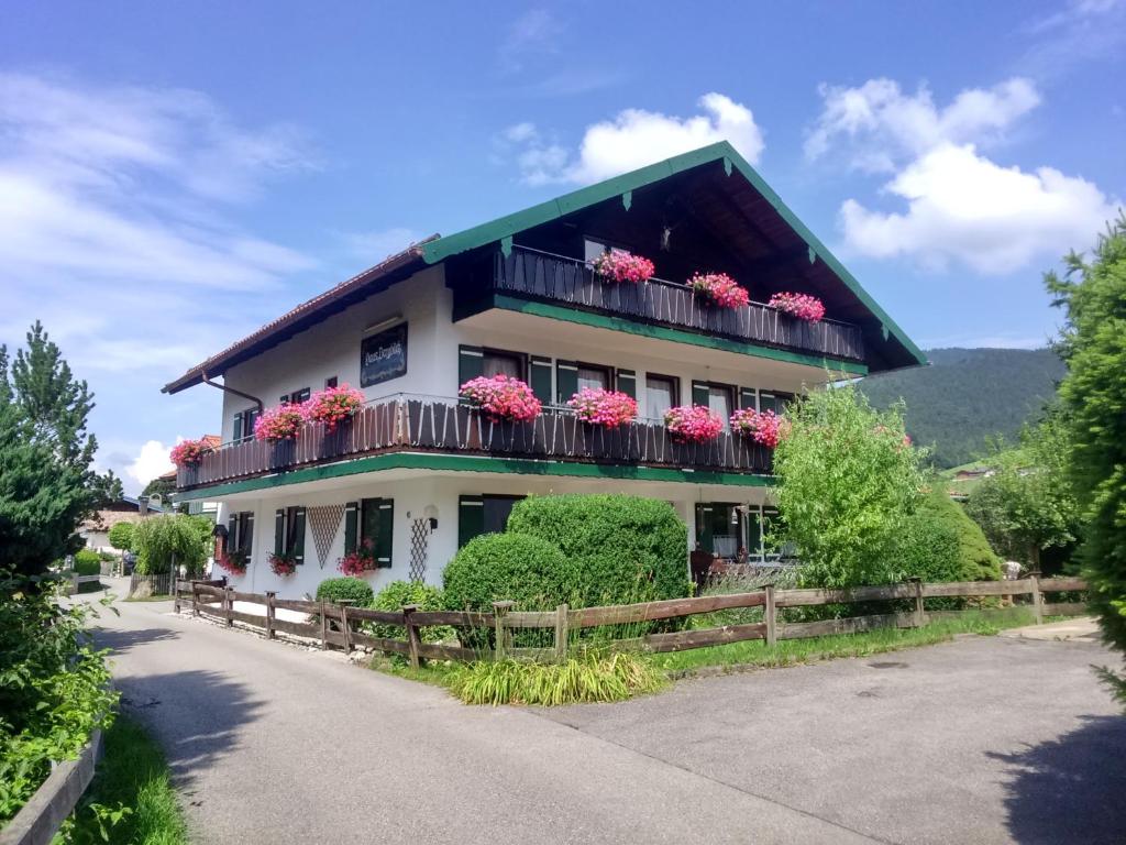 a house with flower boxes on the balconies at Pension Bergblick in Ruhpolding