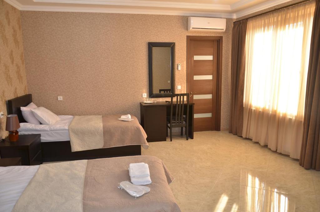 Postel nebo postele na pokoji v ubytování Hotel New Telavi