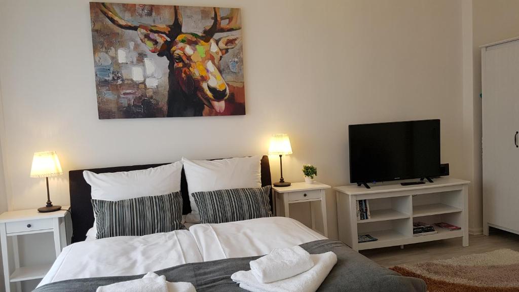 a bedroom with a bed and a flat screen tv at City Apartment, good location in Berlin