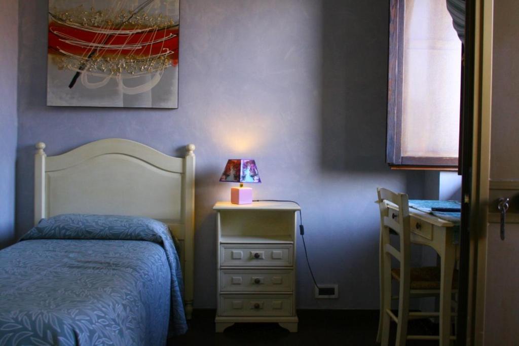 Postel nebo postele na pokoji v ubytování Albergo Vecchio Pavone