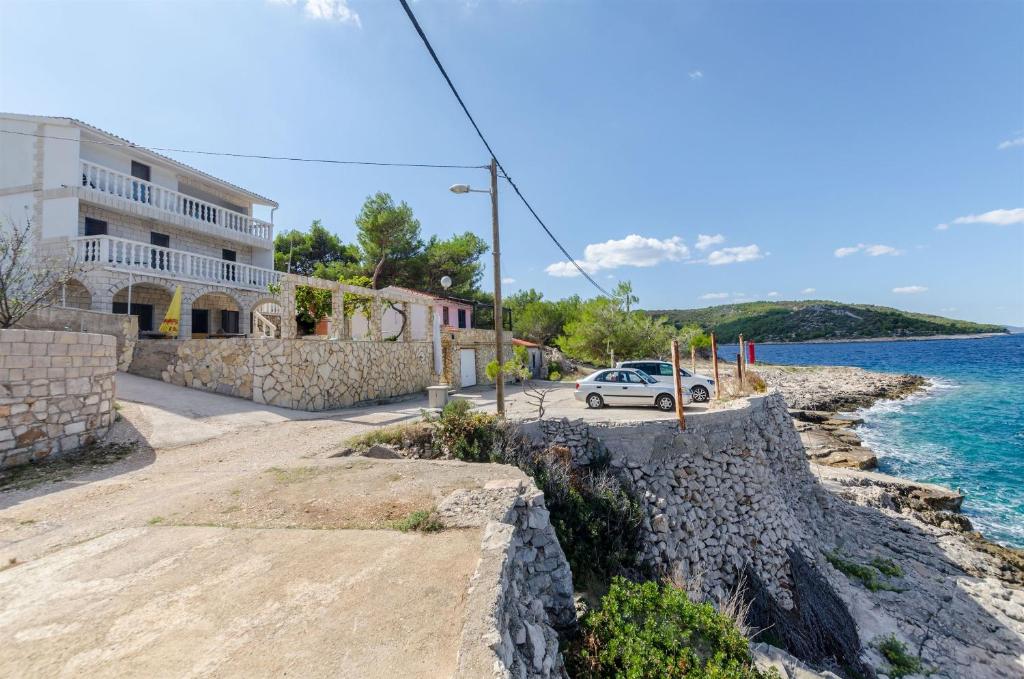a car parked on a road next to the ocean at Apartment Barba in Rogač