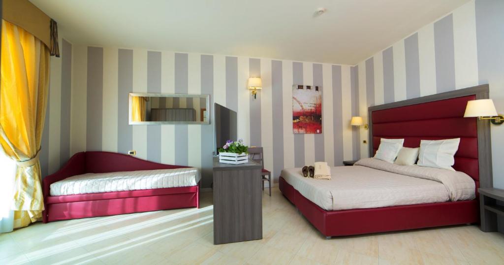 Postel nebo postele na pokoji v ubytování Grand Hotel Elite