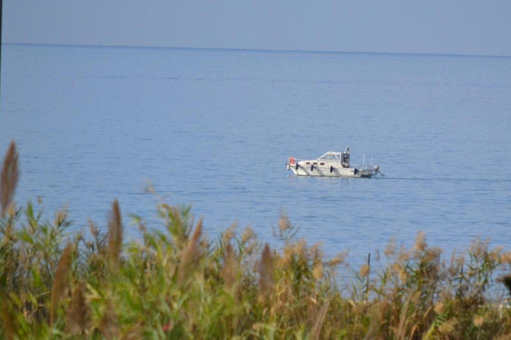 a small boat floating in the middle of the water at Villa Arechi in Salerno