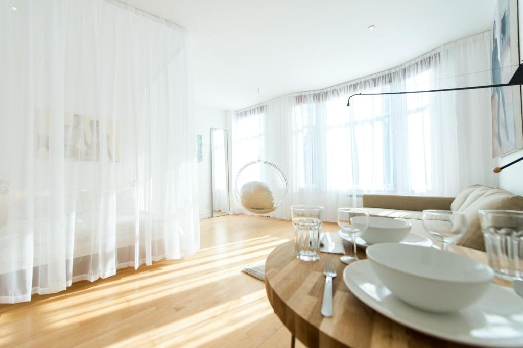 a dining room with a table with white dishes on it at The Charterhouse, Farringdon, by the Design Traveller in London