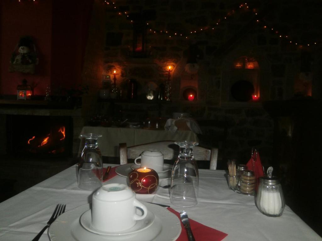 a table with a white table cloth with a candle on it at Thea Valtessinikou in Valtessiniko