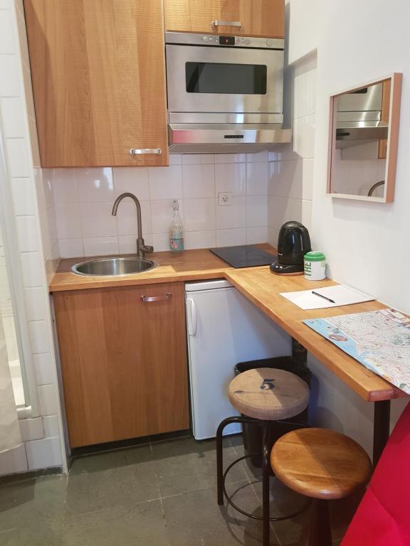 a small kitchen with a sink and a counter at Studette en plein cœur du Vieux Nice in Nice